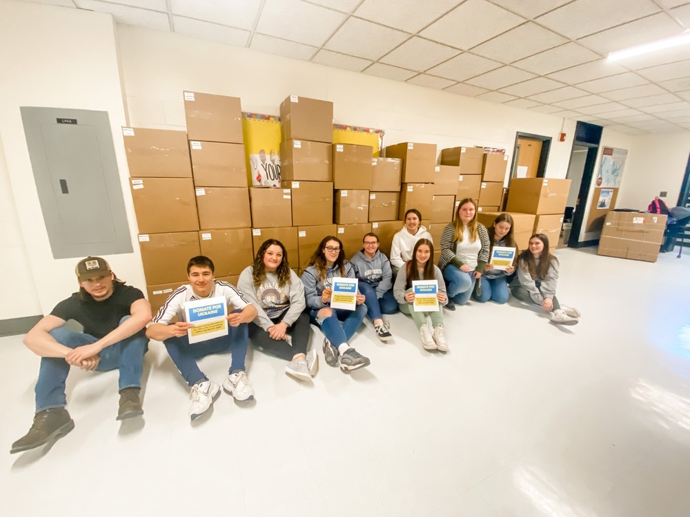 Junior and Senior Honor Society members sitting after packing boxes for donation