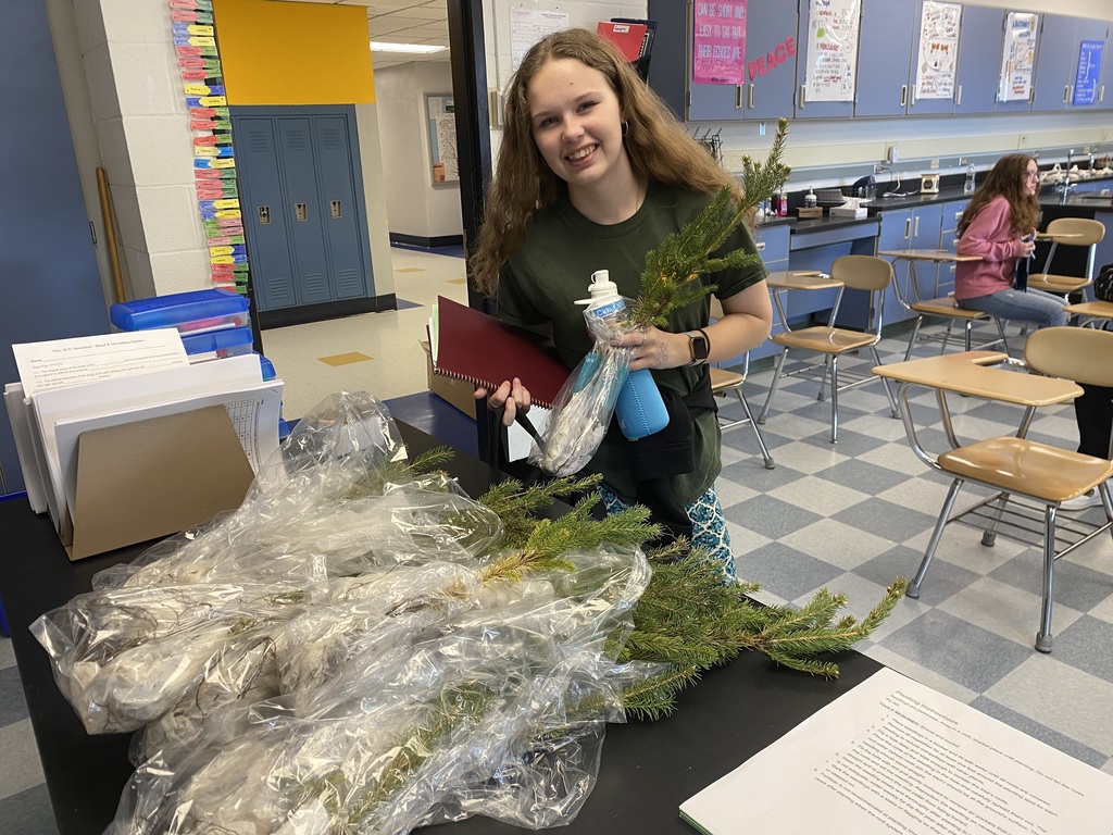 student with saplings